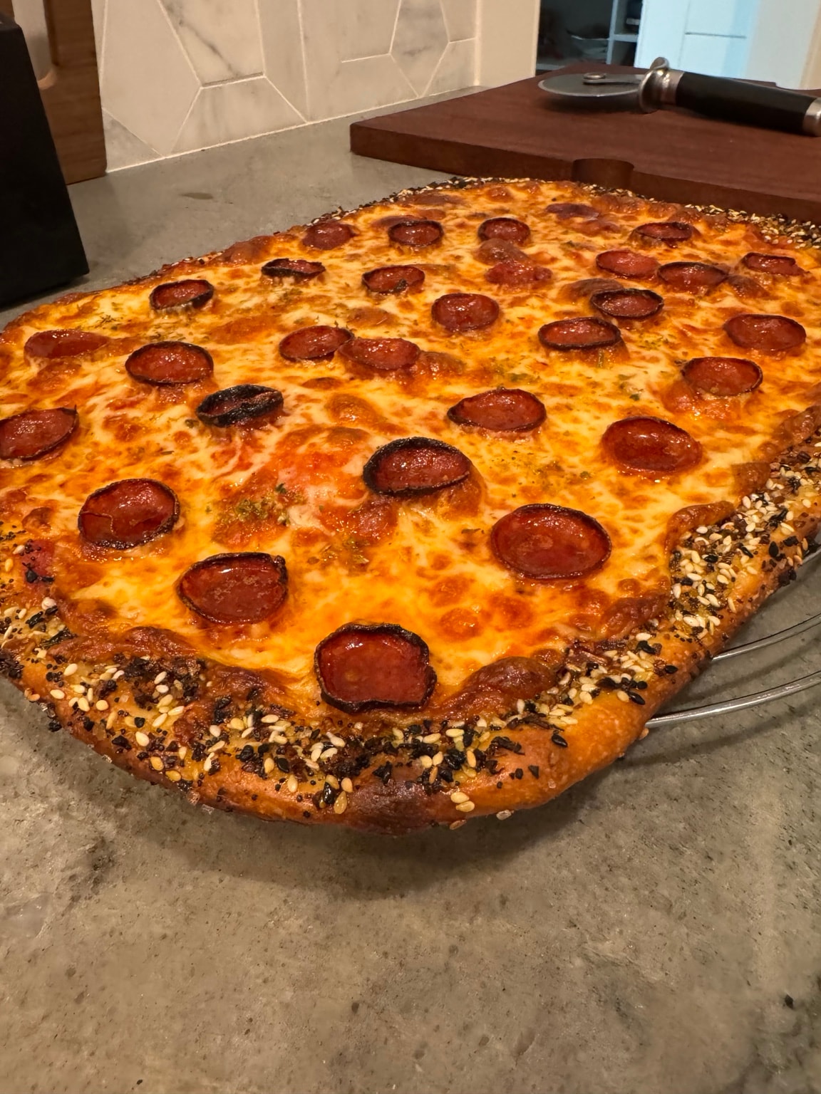 Greg's pepperoni pizza seeded crust close-up