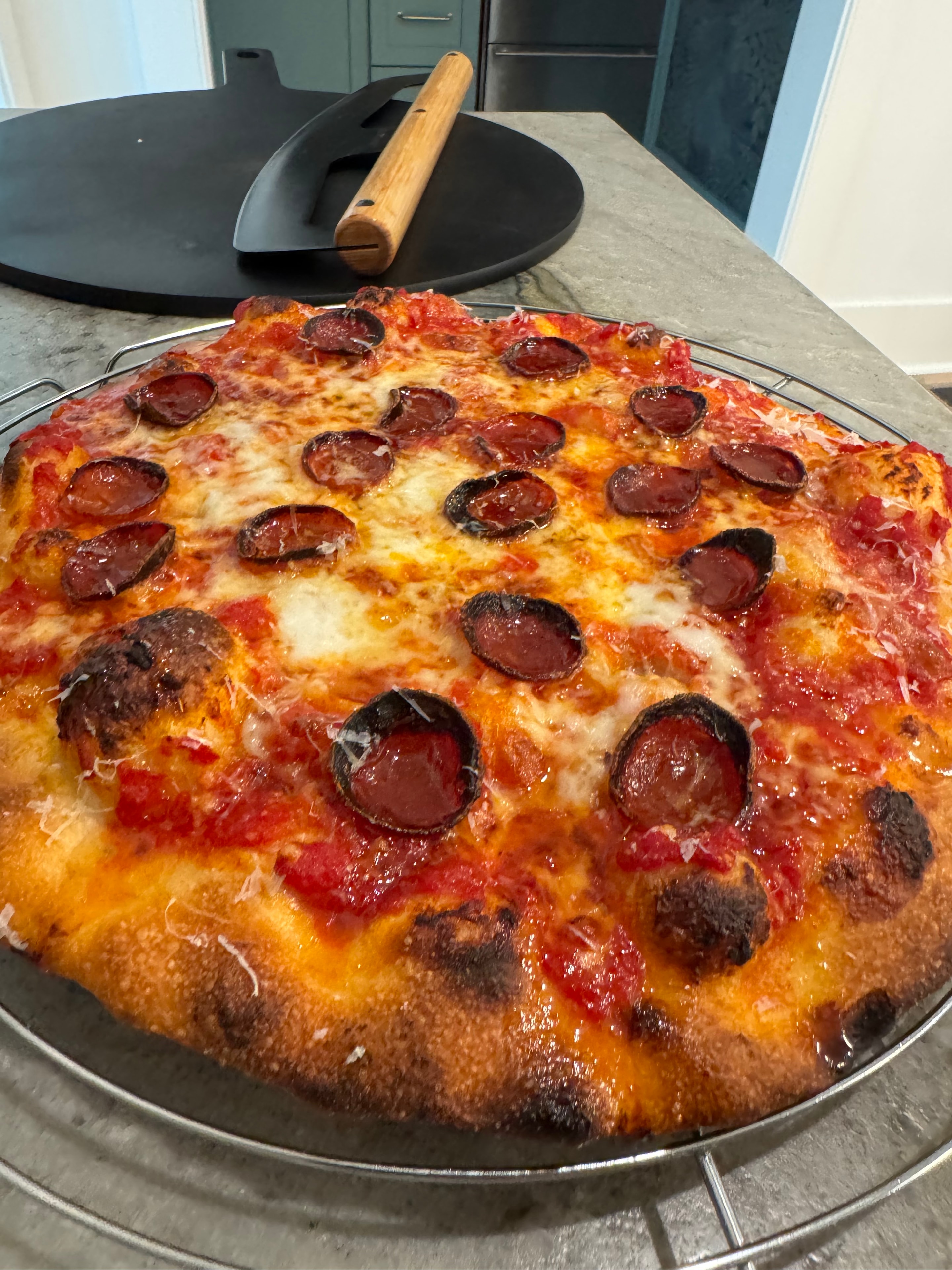 Greg's charred pepperoni pizza on wire rack