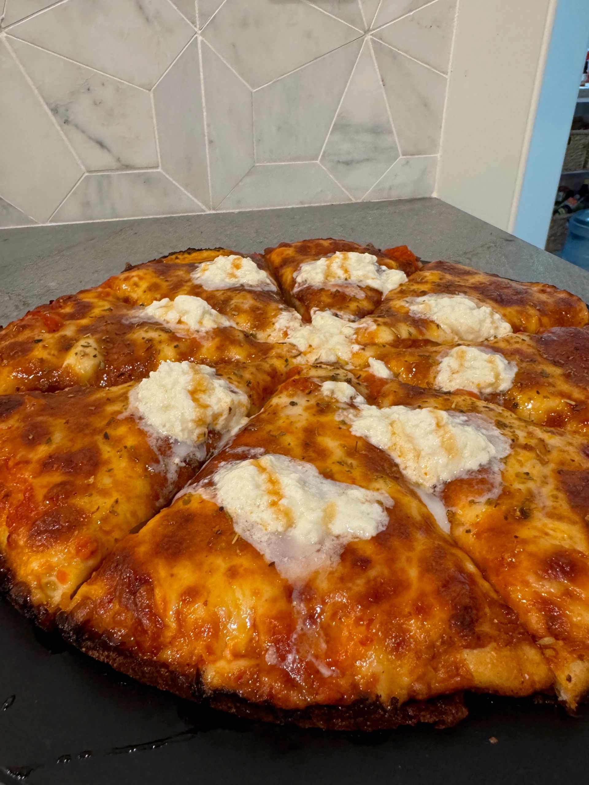 Ricotta pizza marble backsplash artisan kitchen