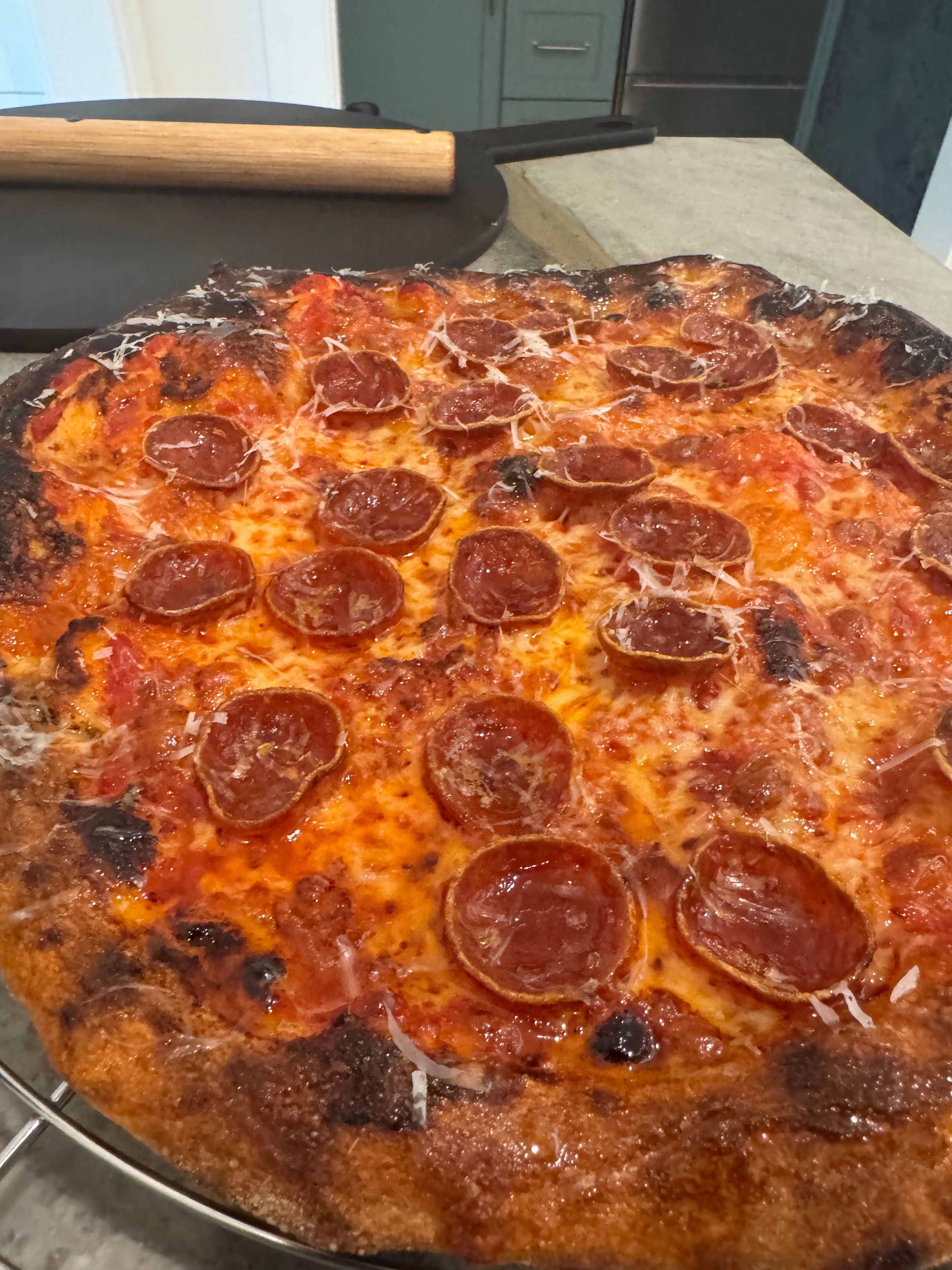 Greg's pepperoni pizza charred crust close-up