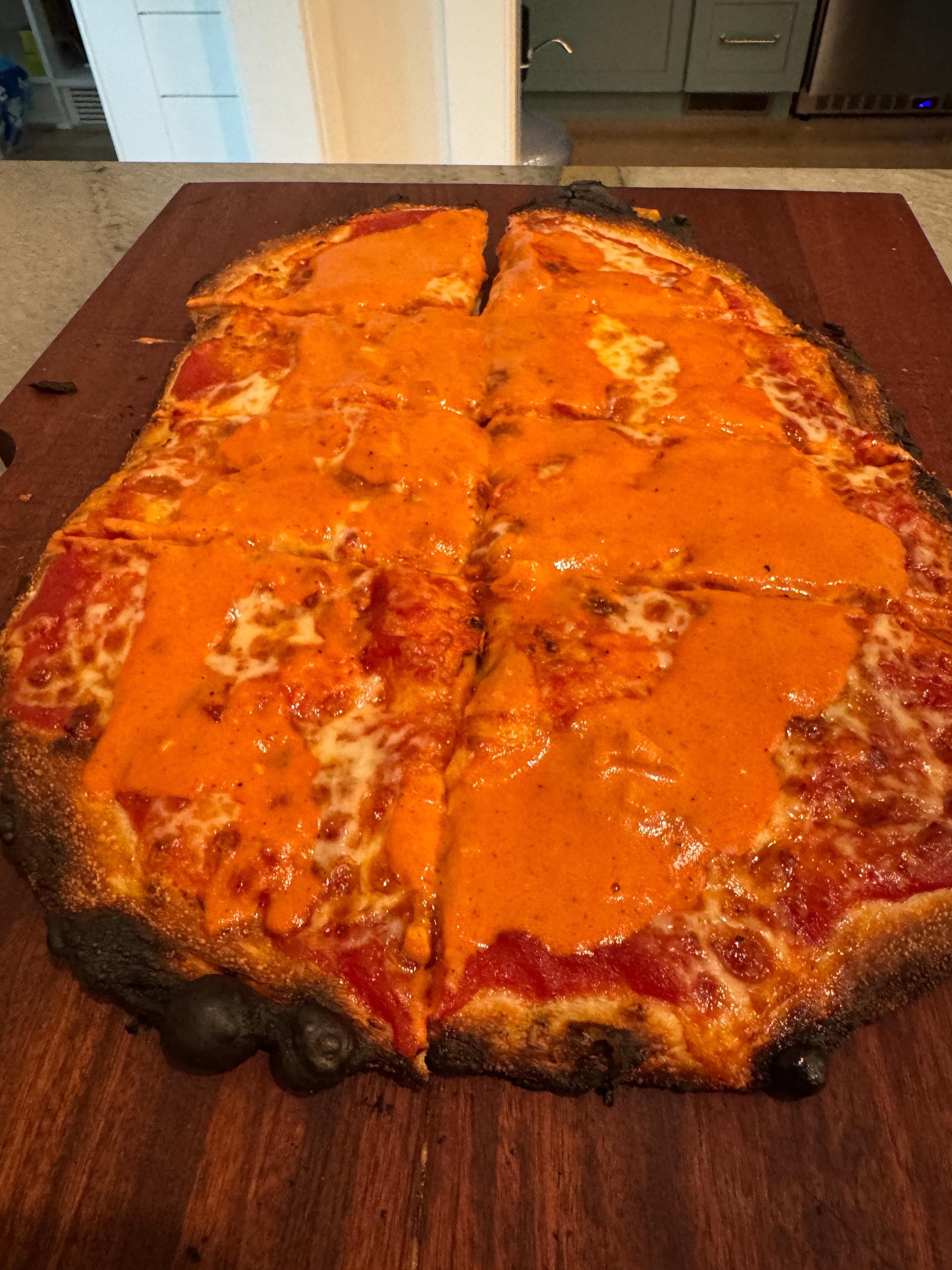 Greg's vodka sauce rectangular pizza on wood board